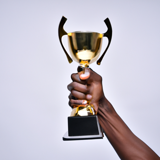 Image of a person holding a trophy in celebration of reaching a goal